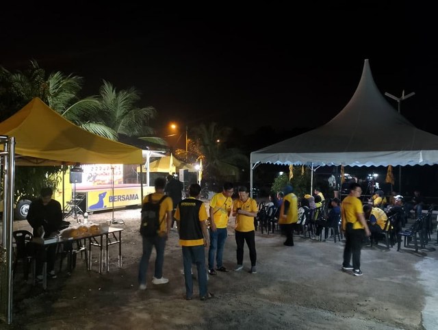 Petugas dan pengunjung berkumpul di kawasan khemah berhampiran pentas.